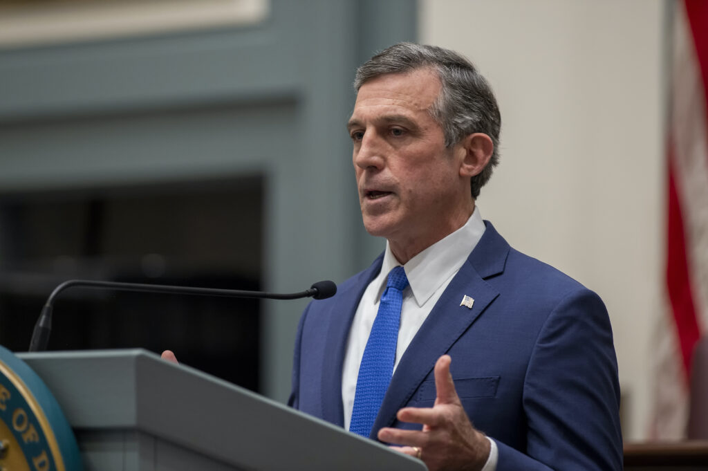 Delaware Gov. John Carney speaks at a podium