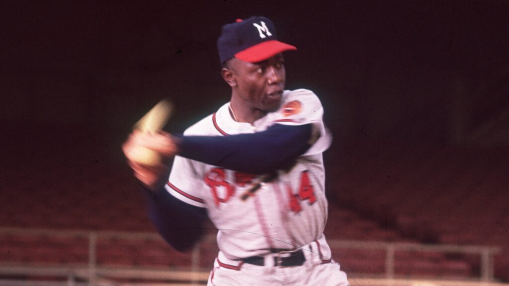 Legendary baseball player Hank Aaron has died at the age of 86. circa 1955: American baseball player Hank Aaron swings a bat in an empty stadium. (Photo by Hulton Archive/Getty Images)