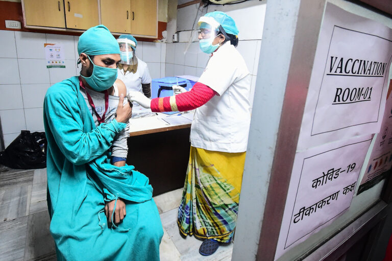 Volunteers and health officials hold a dry run for the coronavirus vaccine at a hospital in Allahabad