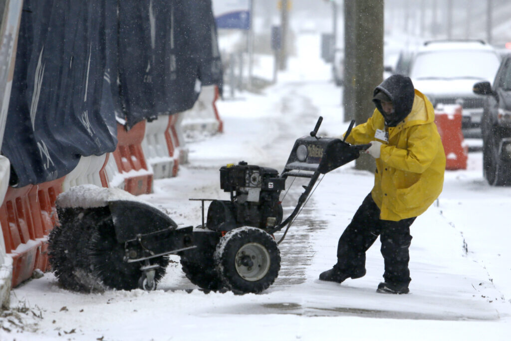 Winter Weather Pennsylvania A man works to turn his snow-clearing machine