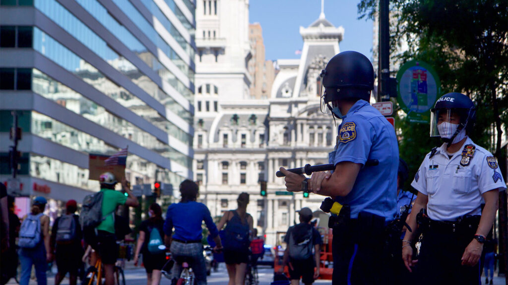 policewatchprotesters-cityhall-bikes-crop PPD officers watch protesters during a demonstration decrying police violence. (Kimberly Paynter / WHYY)
