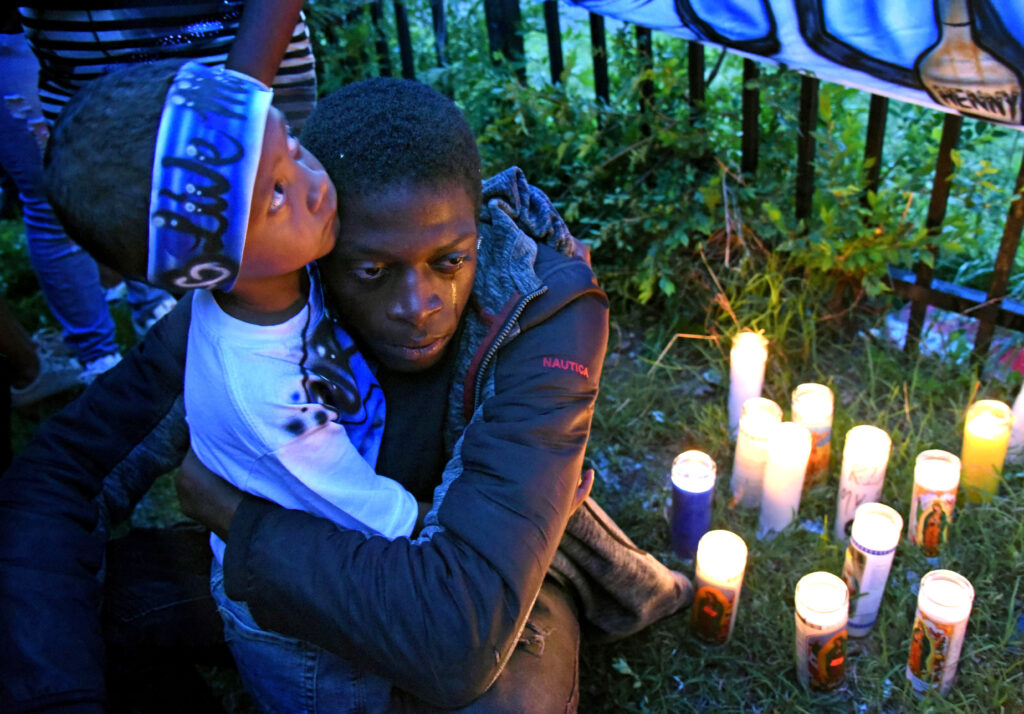 03 At a May 2019 vigil for Michael Thomas in Camden, Thomas' son, Major Thomas is embraced by Michael Thomas' brother, Shaqjuan Randall. (April Saul / WHYY)