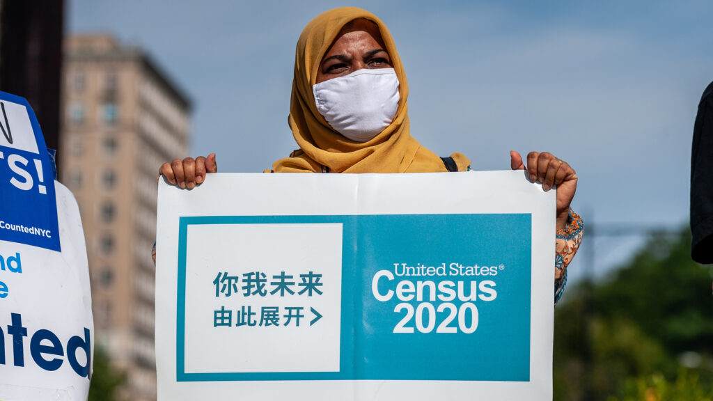 A census supporter holds up a sign during a 2020 rally in New York City. An activist holds up a sign