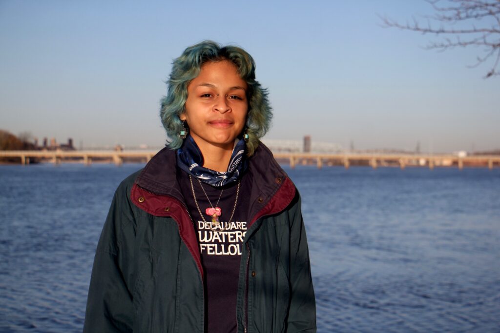 2020 11 20-e lee-adrianna amador chacon-camden cramer hill wildlife preserve-watershed portrait Adrianna Amador-Chacon, 20, of Camden, stands near the Delaware River at Cramer Hill Nature Preserve. (Emma Lee/WHYY)