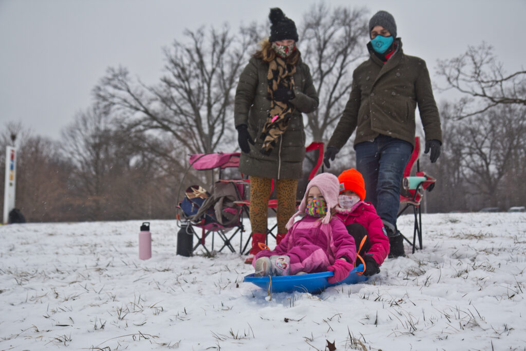 2021 02 01 k paynter sledding snow feb 1 2021-3 Natasha Mell-Taylor, Jared Greenwald, their child Juniper, and friend Phoebe sled at Fairmount Park