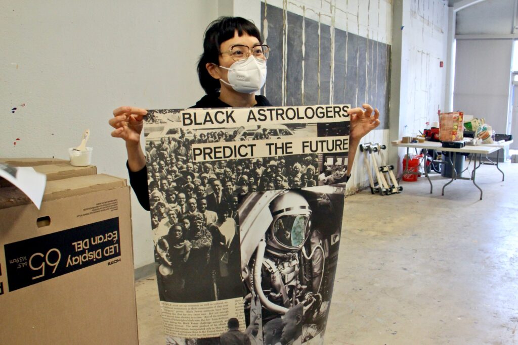 2021 02 03-e lee-anne ishii-philadelphia asian arts initiative moor mother Anne Ishii holds up a poster at an exhibit
