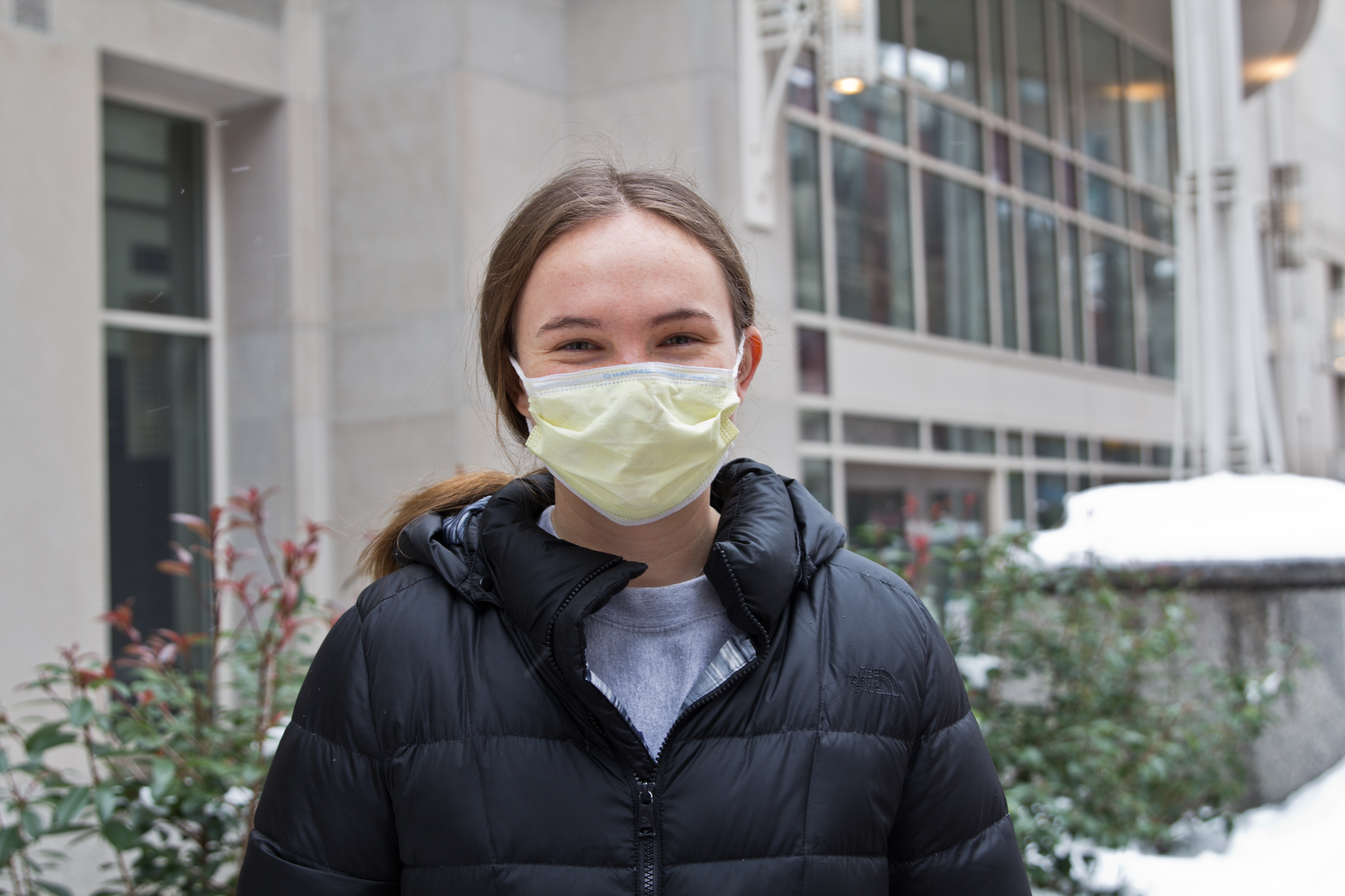 Ellie Cline, wearing a face mask, stands outside the vaccine clinic