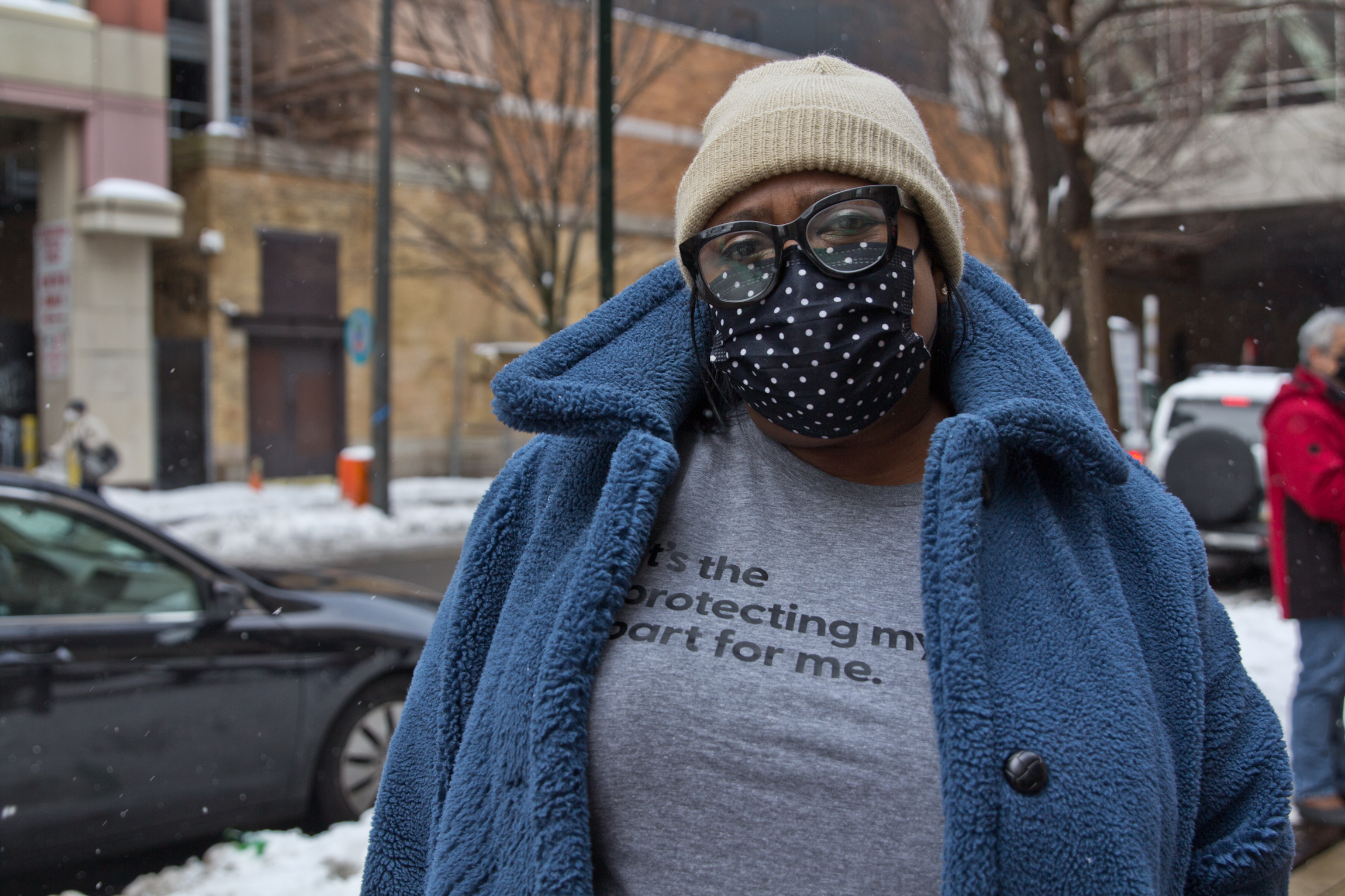 Lisa Myers, wearing a face mask, stands outside Philly's COVID vaccine clinic