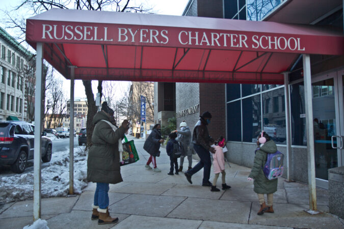 Sharon Stewart (left) takes a photo of her granddaughter (right) outside of Russell Byers Charter school