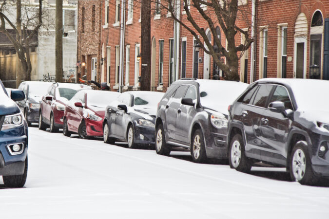 Cars parked on Philly street in the snow