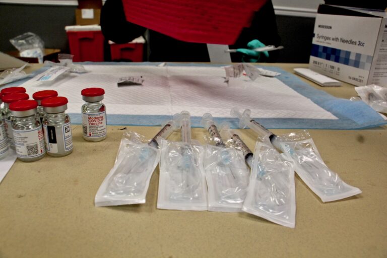 Doses of Moderna's COVID-19 vaccine are prepared at the Liacouras Center, where the Black Doctors Consortium held a 24-hour mass vaccination clinic on Feb. 19, 2021. (Emma Lee/WHYY)