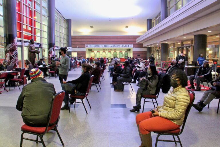 Philadelphians wait in the lobby of the Liacouras Center at Temple University to recieve the Moderna COVID-19 vaccine. The 24-hour vaccination event was organized by the Black Doctors COVID-19 Consortium. (Emma Lee/WHYY)