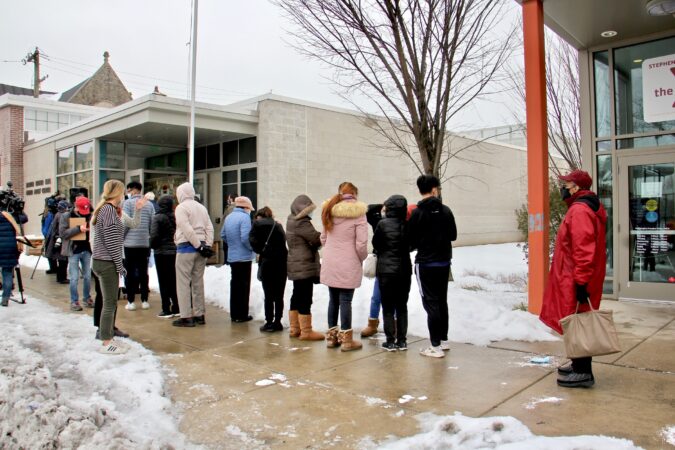 People wait in line for COVID-19 vaccines