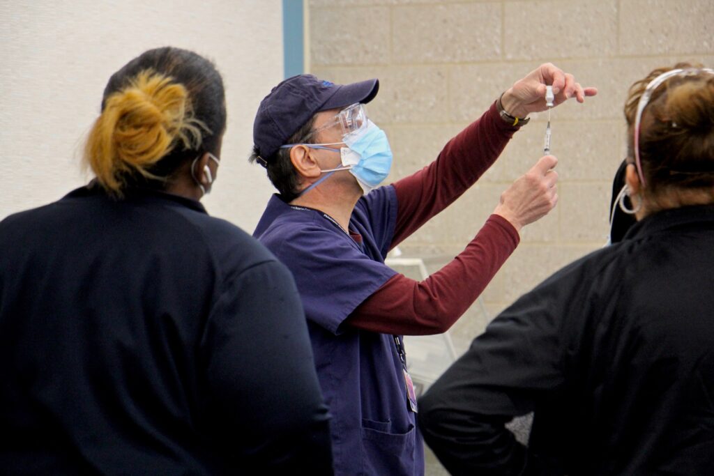 2021 02 23-e lee-philadelphia martin luther king older adult center-covid 19 vaccination clinic syringe A staff member demonstrates how to prepare a dose at Philadelphia's COVID-19 vaccine center