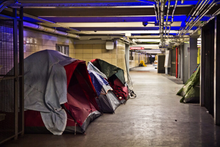 Tents and sleeping bags line the tunnels of the Locust Street Patco Station in Center City on Feb. 23, 2021. (Kimberly Paynter/WHYY)