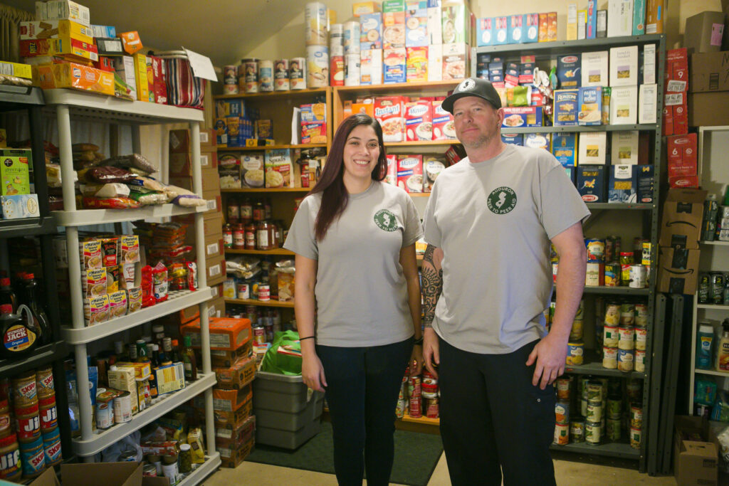 Hounds walk to help save others of their kind Kelli Aceto and Steve Radie from Audubon Peer to Peer Aid pose at the group's pantry in Audubon, N.J. on Thursday, Feb. 25, 2021. (Miguel Martinez for WHYY)