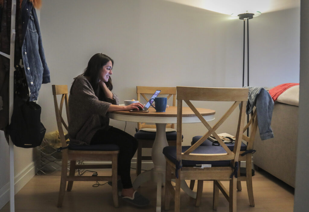 Virus Outbreak Workplace In this March 11, 2020, photo, Lindsay Garfield works from home in New York. Garfield said she gets more done without the constant office interruptions. (AP Photo/Bebeto Matthews)