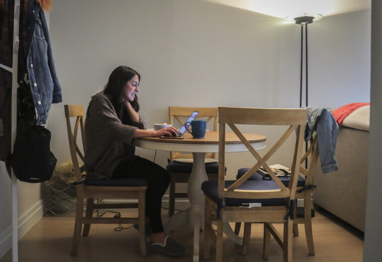 In this March 11, 2020, photo, Lindsay Garfield works from home in New York. Garfield said she gets more done without the constant office interruptions. (AP Photo/Bebeto Matthews)
