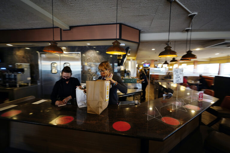 Managers Yllka Murati, left, and Cynthia Branche organize takeout orders at the Penrose Diner, Tuesday, Nov. 17, 2020, in South Philadelphia. (AP Photo/Matt Slocum)