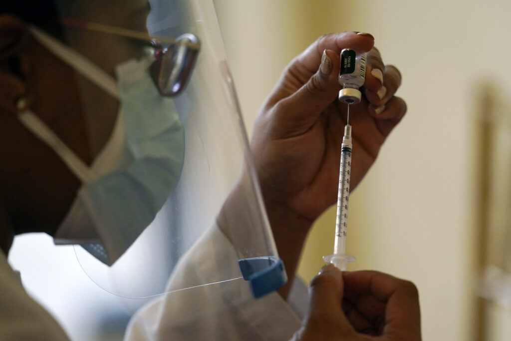 A worker prepares a syringe with the COVID-19 vaccine A worker prepares a syringe with the COVID-19 vaccine