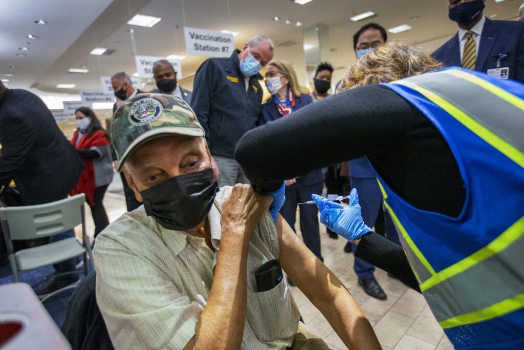 Virus Outbreak New Jersey New Jersey Gov. Phil Murphy (background) listens to New Jersey Department of Health Commissioner Judy Persichilli as World War II veteran Clarence Williams get vaccinated for COVID-19. (Alejandro A. Alvarez/The Philadelphia Inquirer via AP, Pool)