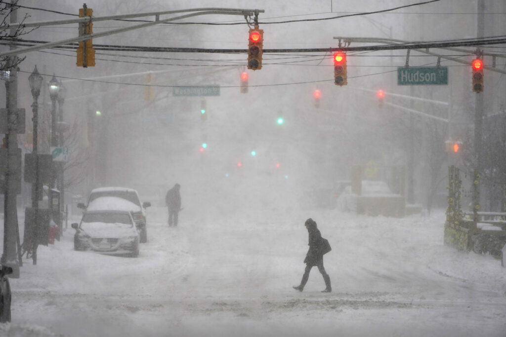 APTOPIX Winter Weather New Jersey File photo: A few pedestrians are seen walking in the heavy snow and wind in Hoboken, N.J., Monday, Feb. 1, 2021. (AP Photo/Seth Wenig)