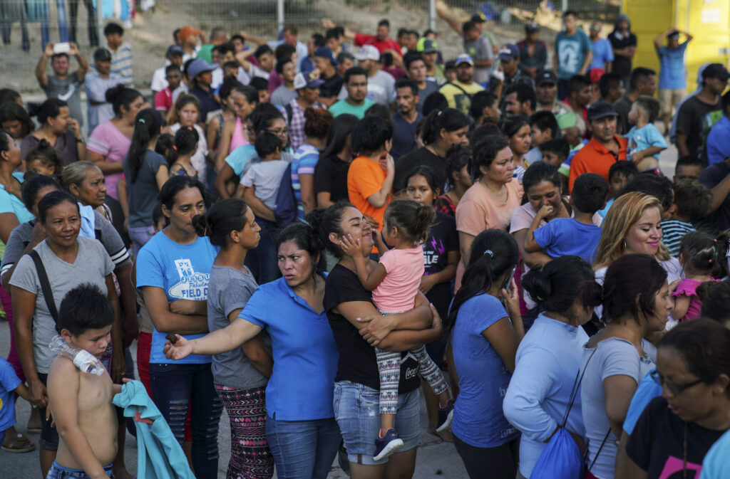 In this Aug. 30, 2019, file photo, migrants, many of whom were returned to Mexico under the Trump administration's 