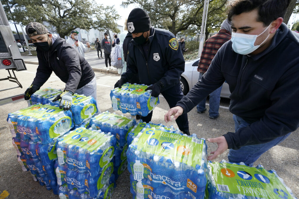 Winter Weather Texas Donated water is distributed to residents, Thursday, Feb. 18, 2021, in Houston. Houston and several surrounding cities are under a boil water notice as many residents are still without running water in their homes. (AP Photo/David J. Phillip)