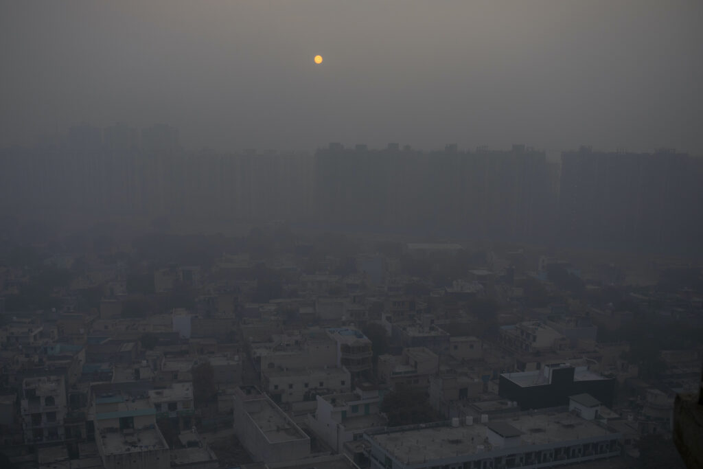 UN Climate Falling Short In this Saturday, Jan. 2, 2021 file photo, the morning sun is seen through a blanket of smog on the outskirts of New Delhi, India. (AP Photo/Altaf Qadri)