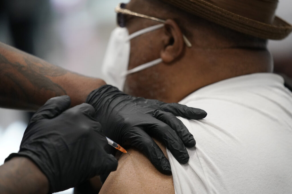 Virus Outbreak Vaccine FILE - In this Feb. 10, 2021, file photo, a man receives a COVID-19 vaccine at the Martin Luther King Senior Center in North Las Vegas. The nation is poised to get a third vaccine against COVID-19, but health officials are concerned that at first glance the Johnson & Johnson shot may not be seen as equal to other options from Pfizer and Moderna. (AP Photo/John Locher, File)