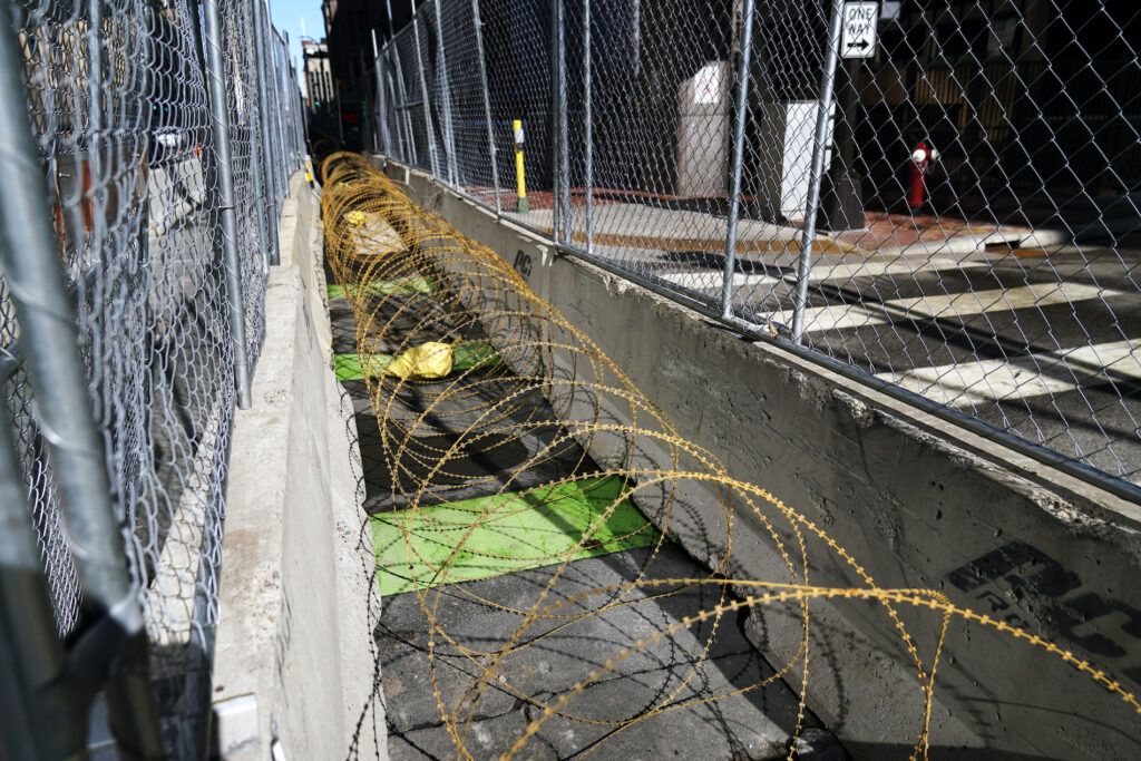 George Floyd Trial Uneasy City Concertina wire sits between fenced barriers outside the Hennepin County Government Center, Wednesday, Feb. 23, 2021, in Minneapolis, as part of security in preparation for the trial of former Minneapolis police officer Derek Chauvin. (AP Photo/Jim Mone)