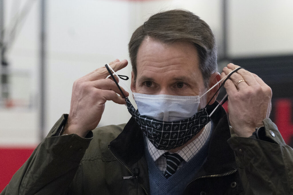 Virus Outbreak Connecticut Vaccines Congressman Jim Himes, D-Conn., adjusts his two masks