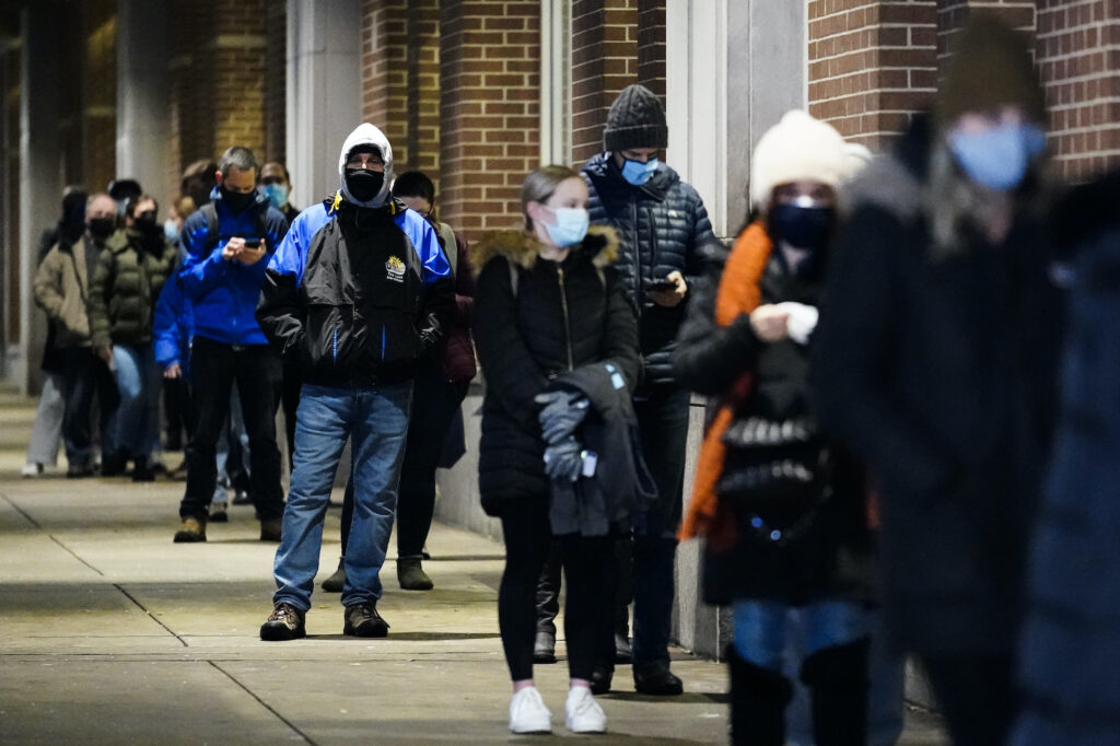 Virus Outbreak-Pennsylvania People wait in line at a COVID-19 vaccination site at the Pennsylvania Convention Center