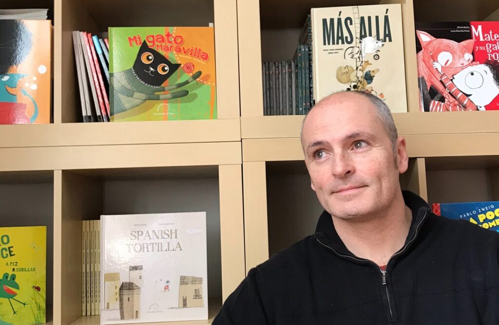 Enrique Moras Enrique Morás stands in front of a bookshelf