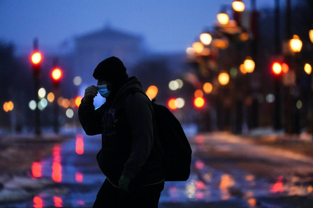 Winter Weather Pennsylvania A person wearing a face mask as a precaution against the coronavirus walks during a winter storm in Philadelphia