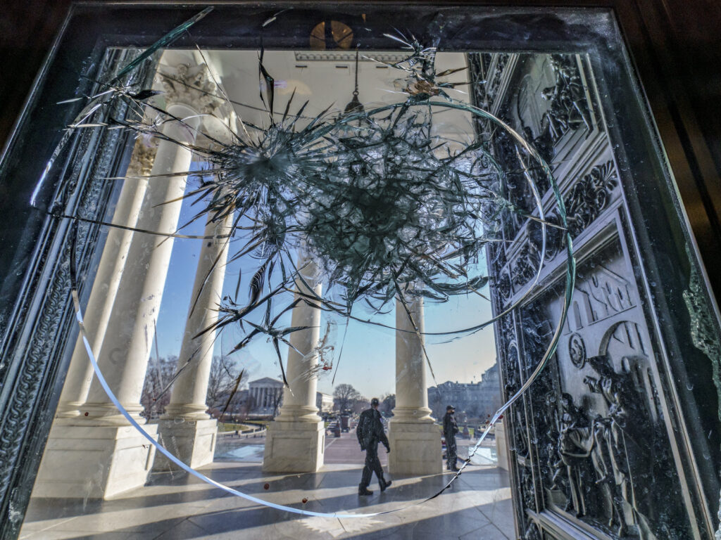 Shattered glass from the attack on Congress by a pro-Trump mob is seen in the doors leading to the Capitol Rotunda.