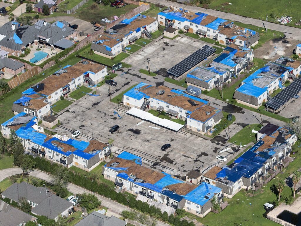 Blue tarps cover houses with damaged roofs in Lake Charles, La., after Hurricane Delta hit the city in October 2020. Blue tarps cover houses with damaged roofs in Lake Charles, La., after Hurricane Delta hit the city in October 2020. (Bill Feig/AP)