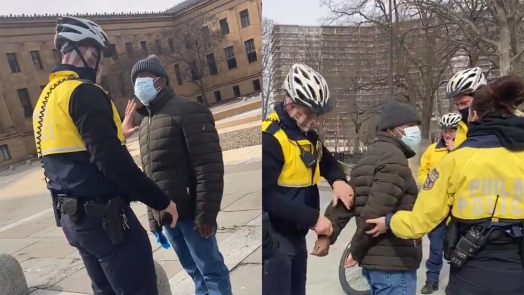 A swarm of Philadelphia police officers arrest a man they accused of soliciting money in return for photos outside the Philadelphia Museum of Art. (Claire Wolters)