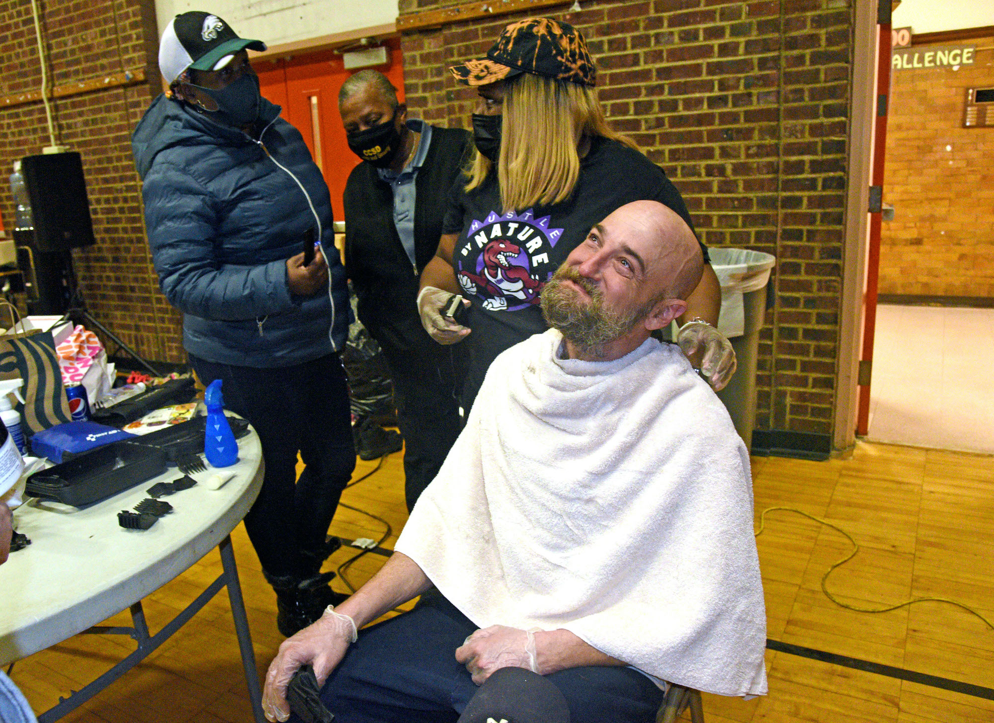 Tawanda Jones gives a patron a haircut.