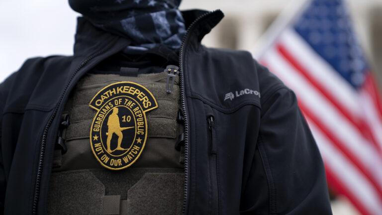 A demonstrator wears an Oath Keepers anti-government organization badge on a tactical vest during a protest outside the Supreme Court in Washington, D.C., on Jan. 5, 2021. (Stefani Reynolds/Bloomberg via Getty Images)