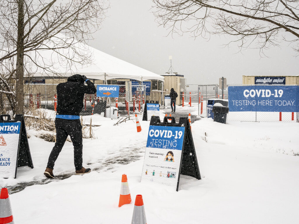The Biden administration announced on Wednesday a range of initiatives to expand testing capacity in the U.S. A COVID-19 testing site in Seattle is seen here on Saturday. People enter a COVID-19 testing site in the snow