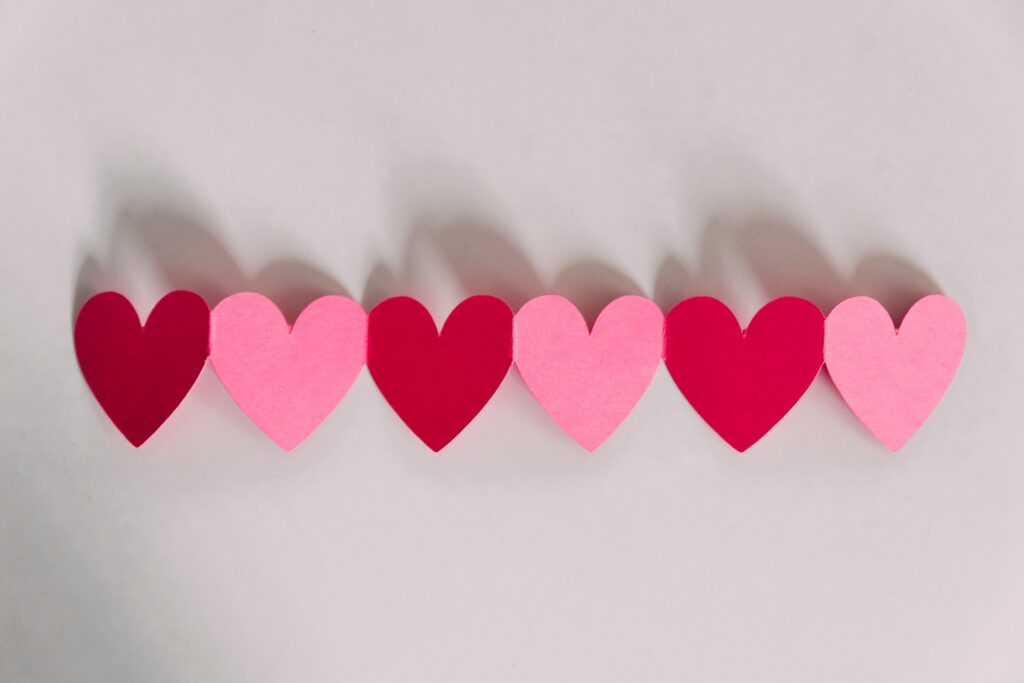 kelly-sikkema-mywUlDDkHiU-unsplash Red and pink paper hearts for Valentines Day