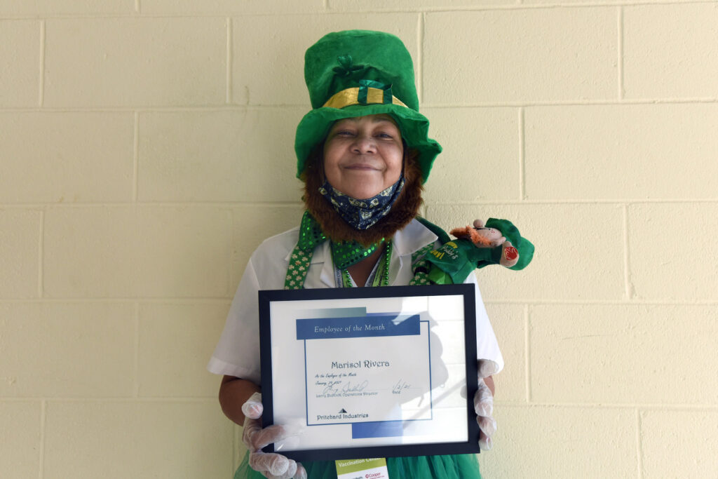 marisol1 On January 27 at the COVID-19 vaccination center at Camden County College in Blackwood, NJ, Marisol Rivera shows off the Prichard Industries Employee of the Month certificate she's just been awarded. (April Saul for WHYY)