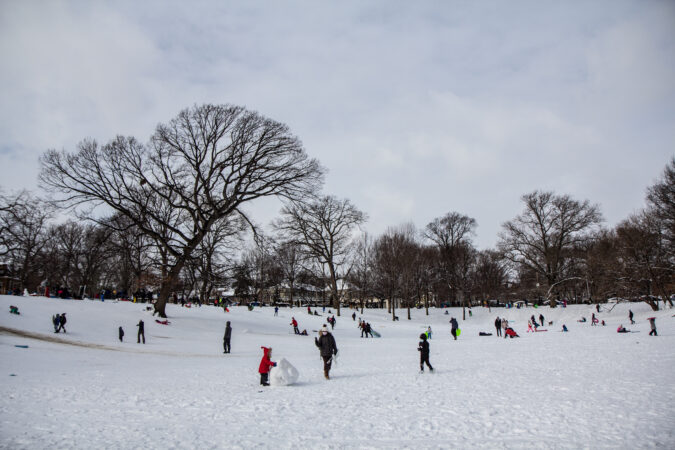 Residents play in the snow at Clark Park