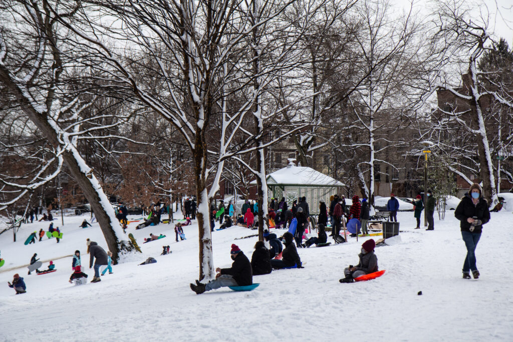 Clark park was packed with sledders Tuesday afternoon. (Kimberly Paynter/WHYY) Residents play in the snow at Clark Park