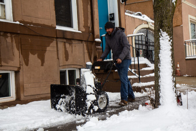 A snowblower clears sidewalks in Philadelphia’s Kensington neighborhood