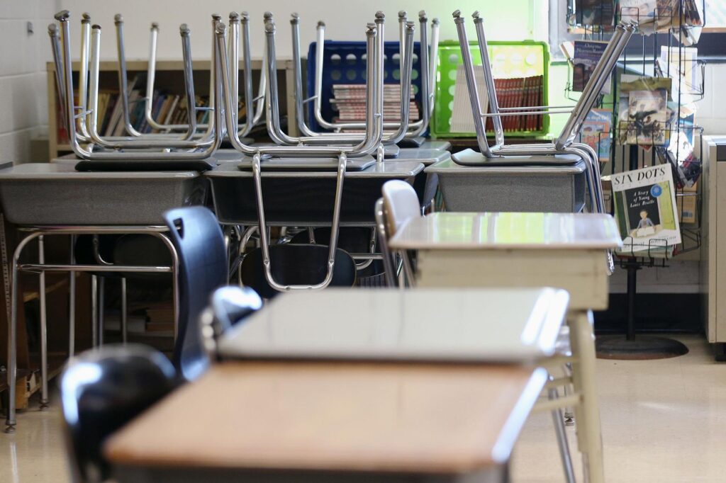 school_desk_chairs_tim_tai_inky_021821 Desks are pictured in an empty classroom.