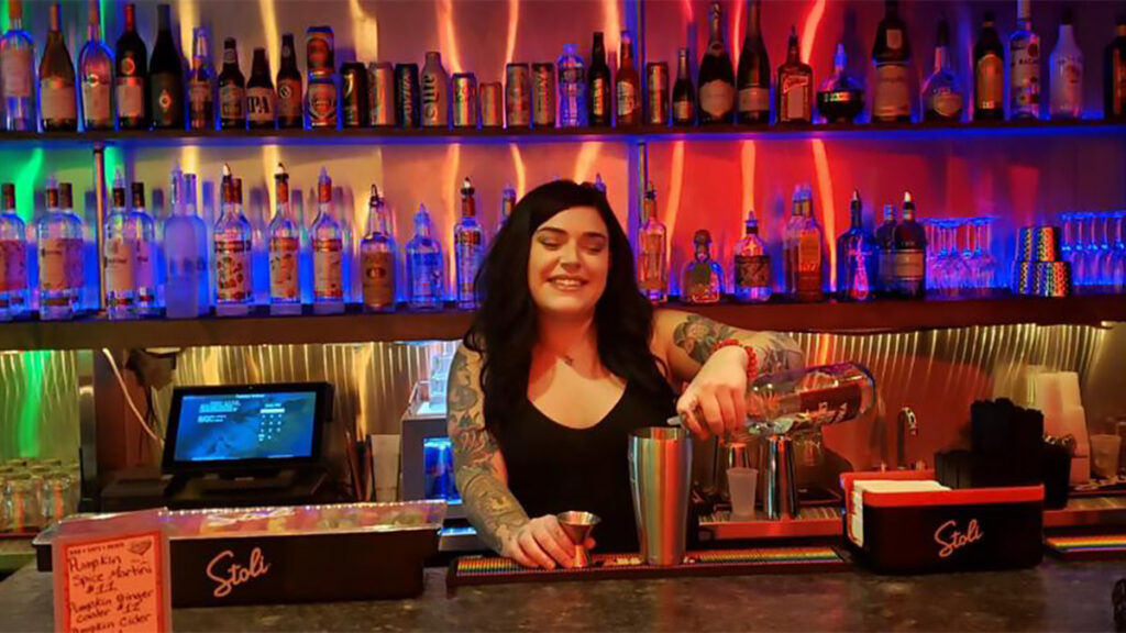 toastedwalnut-bartender A bartender pours a drink at the Toasted Walnut
