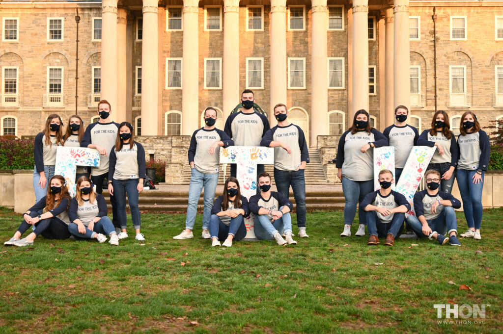 Penn State THON executive leaders sit on campus wearing face masks