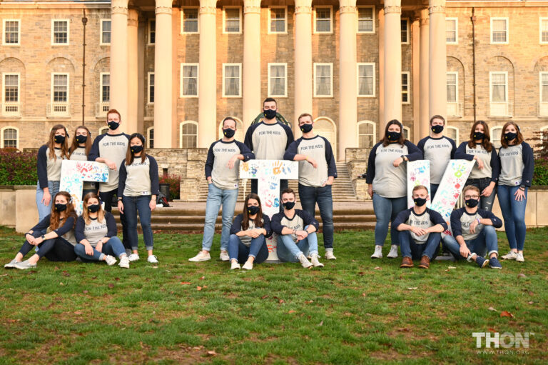 Penn State THON executive leaders sit on campus wearing face masks